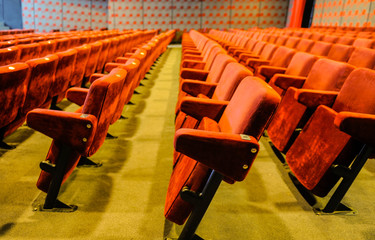 Cinema and music hall with comfortable red seats for audience
