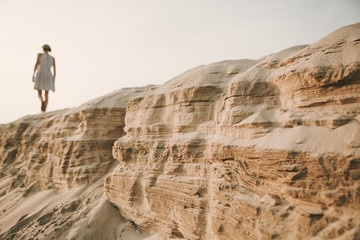 tired girl walking sand desert beach footprints