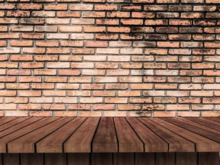 Empty wooden shelf on old brick wall texture