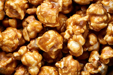 caramel pop corn background. Golden caramel popcorn close up. Background of popcorn. Snacks and food for a movie