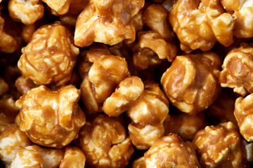 caramel pop corn background. Golden caramel popcorn close up. Background of popcorn. Snacks and food for a movie