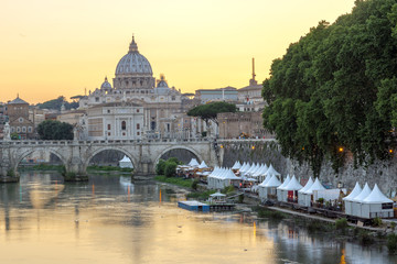 Sunset Panorama of Tiber River, St. Angelo Bridge and St. Peter's Basilica in Rome, Italy