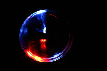 Red, blue and white light radiating out in a sphere