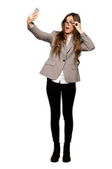 Fototapeta premium Full-length shot of Business woman making a selfie on isolated white background