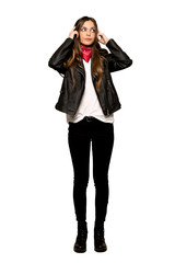Fototapeta premium Full-length shot of Young woman with leather jacket having doubts and thinking on isolated white background