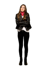 Full-length shot of Young woman with leather jacket with confuse face expression while bites lip on isolated white background