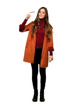 Full-length shot of Young woman with coat making a selfie on isolated white background