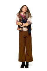 Full-length shot of Young hippie woman making doubts gesture while lifting the shoulders on isolated white background