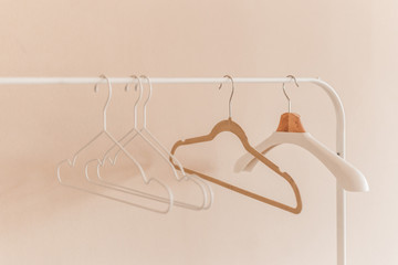wooden coat hangers on clothes rail.