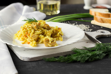 Pilaf, rice with meat, carrots and onions on a white background. Оn a fork.