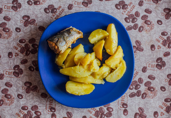 appetizing fried potatoes with fish on a plate