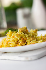 Traditional pilaf, rice with meat, carrots and onions on a white background.