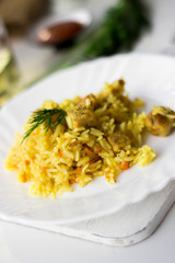 Traditional pilaf, rice with meat, carrots and onions on a white background.