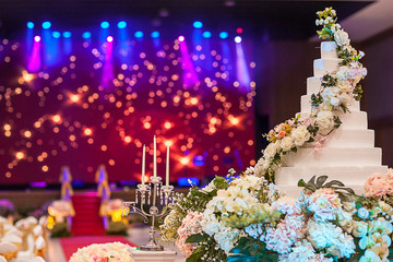 Obraz na płótnie Canvas soft focus wedding cake on flower near wedding candle.