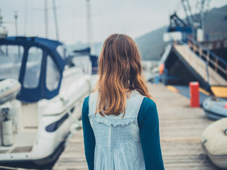 Young woman in marina with boats