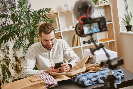 Chatting with subscribers. Male fashion blogger answering on questions after online streaming for his blog