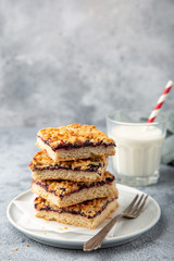 berries jam squares and glass of milk