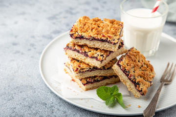 berries jam squares and glass of milk