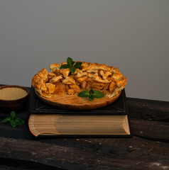 apple cake on a book on a wooden backdrop, rustic style