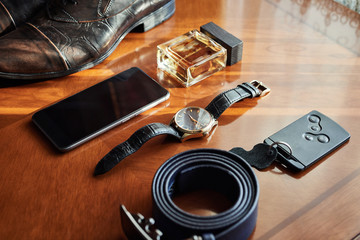 different accessories of a businessman for creating a style of a people lie on a wooden background