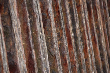 A close up photograph of a rusty old metal sea barrier wall.  Abstract old worn background texture