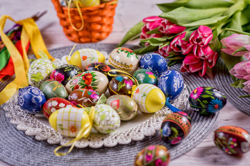 Fototapeta na wymiar Multicolored spring tulips and Easter eggs with decorations