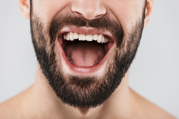 Close up half face portrait of a smiling bearded man