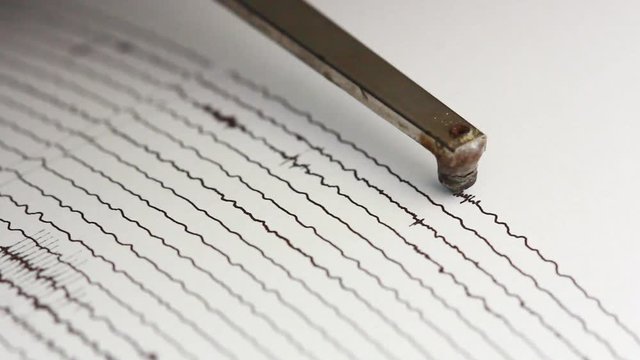 close up drum recorder recording seismic signal on paper