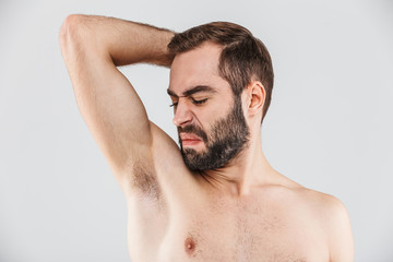 Close up portrait of a disgusted bearded man standing