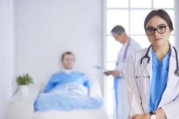 Female doctor using tablet computer in hospital lobby