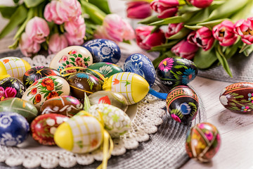 Fototapeta na wymiar Multicolored spring tulips and Easter eggs with decorations