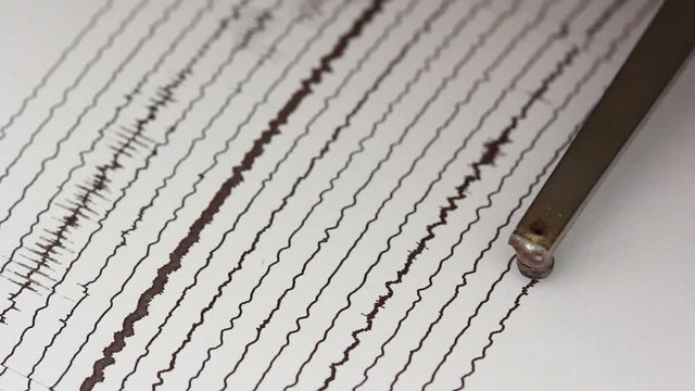 close up drum recorder recording seismic signal on paper