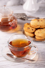transparent teapot and cup of hot tea