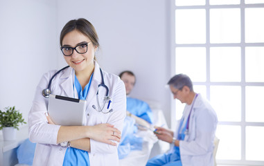 Fototapeta premium Female doctor using tablet computer in hospital lobby