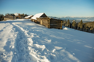 abandoned wooden hut in winter Carpathian mountains. shepherds' huts in the winter Carpathians on...