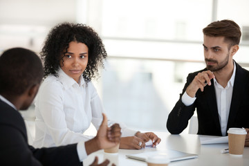 Diverse coworkers gathered in briefing communicating solving business matters
