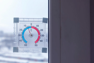Naklejka premium Thermometer on the window with negative temperature in winter.