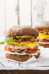 Chicken cheeseburger with bacon, lettuce, tomato and mayonnaise
