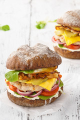 Chicken cheeseburger with bacon, lettuce, tomato and mayonnaise