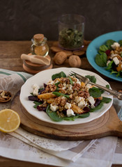 Fototapeta na wymiar Summer vegetable salad with spinach and walnuts