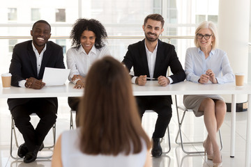 Group of positive diverse people interviewing vacancy applicant 