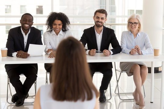 Group of positive diverse people interviewing vacancy applicant 