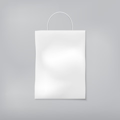 White blank shopping bag with handle is on gray background. Vector illustration.
