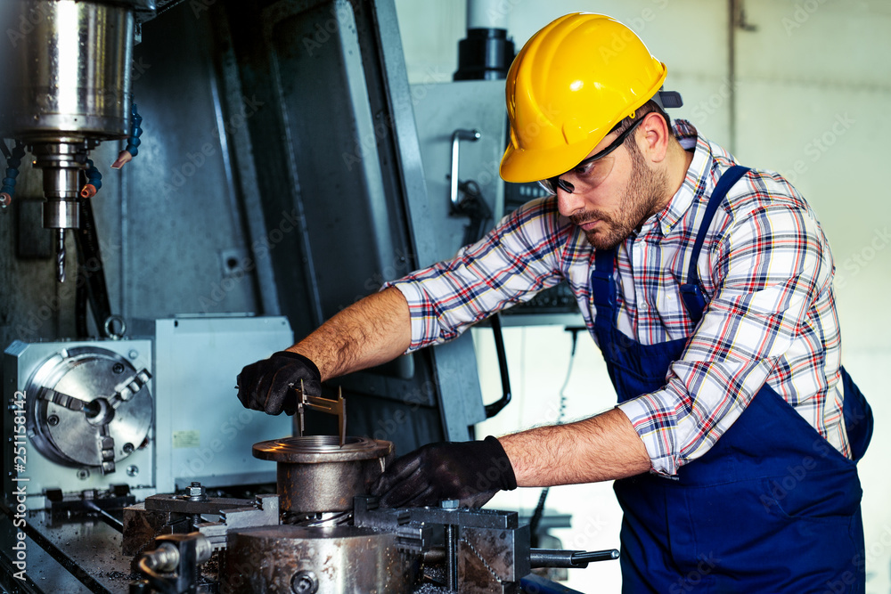 Poster professional engineer metalworker operating cnc milling machine center in manufacturing workshop