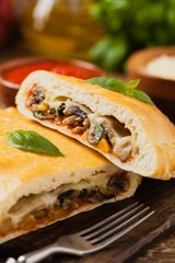 Italian calzone with mushrooms and ham.