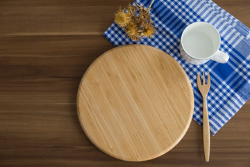 breakfast concept with wooden service plate ,a cup of tea and blue cover for cafe concept.
