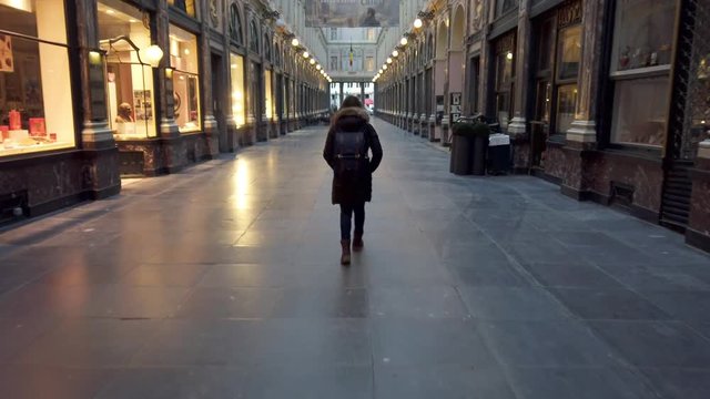 Girl strolling inside the Royal Gallery of Saint Hubert in the center of the city of Brussels
