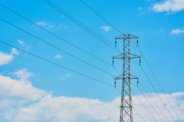 Electric transmission line with steel wires stretched against sky.