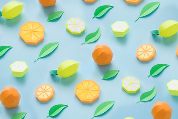Fruit made of paper. Blue background. There's room for writing. Tropics. Flat lay. Orange, lemon.
