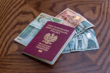 Polish biometric passport with Jordanian dinar banknotes.